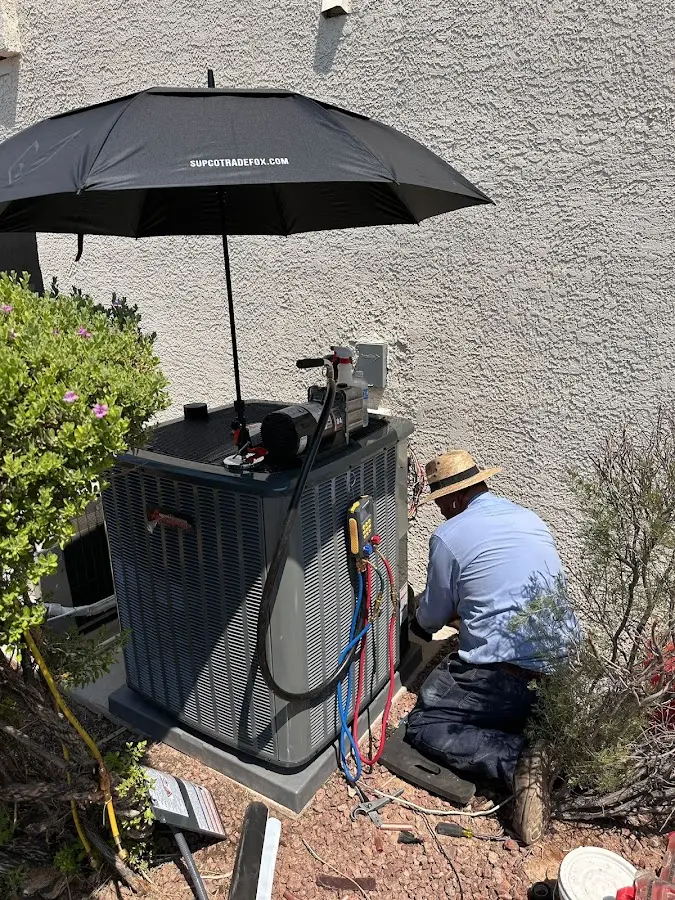 HVAC technician performing outdoor AC maintenance in Shorewood